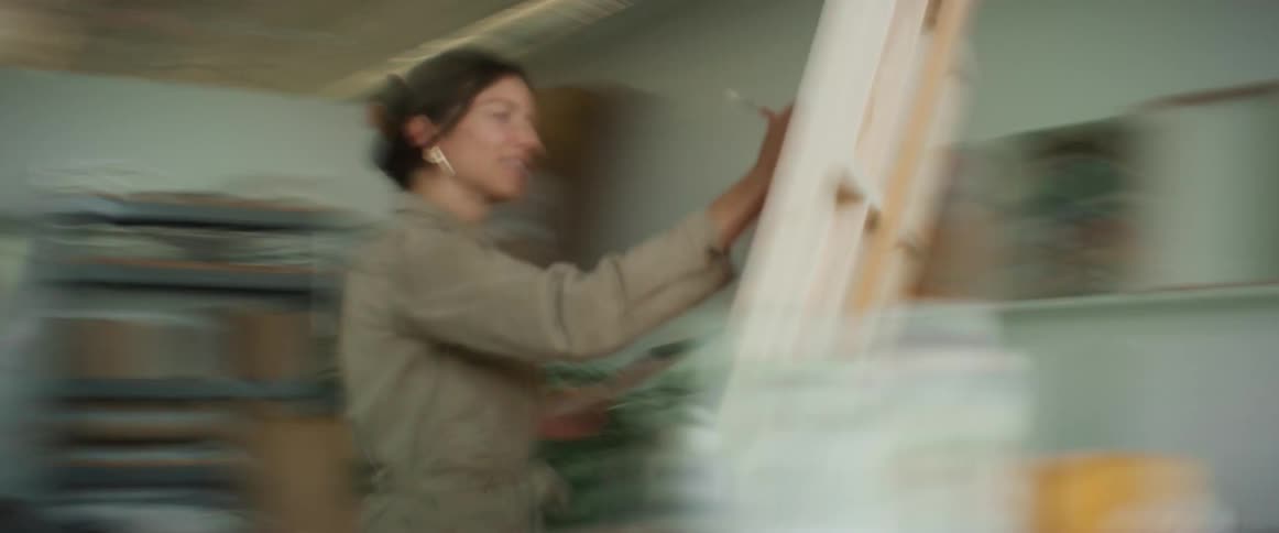 Female artist painting a canvas