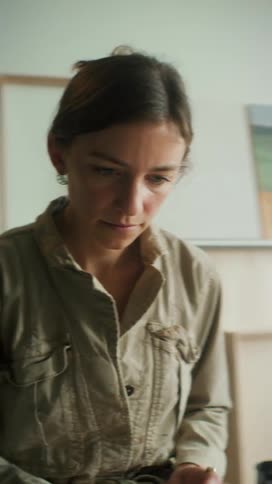 Artist painting in her studio