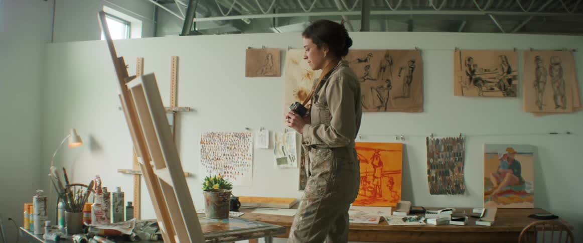 Artist takes pictures of a painting with a camera