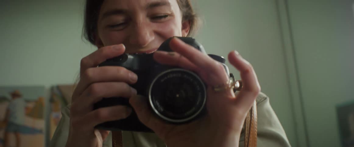 A woman is taking pictures and laughing