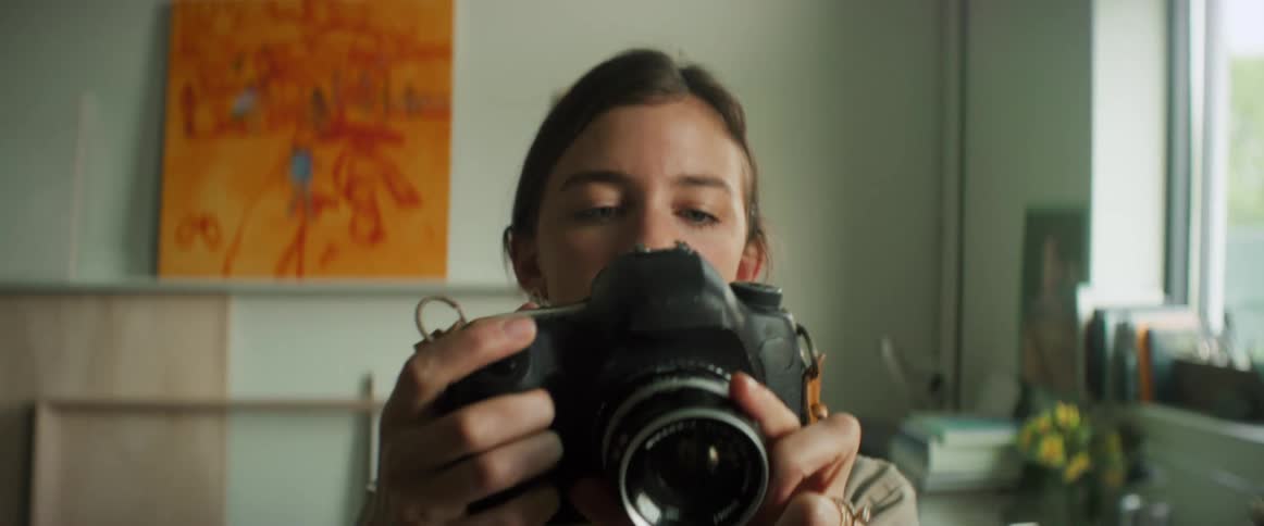 Portrait of a woman taking a photo with a professional camera