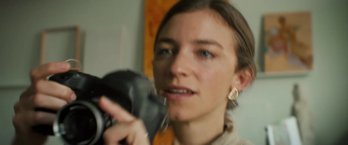 A woman with a camera photographing the environment