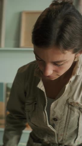 Portrait of a painter applying pigment to a canvas