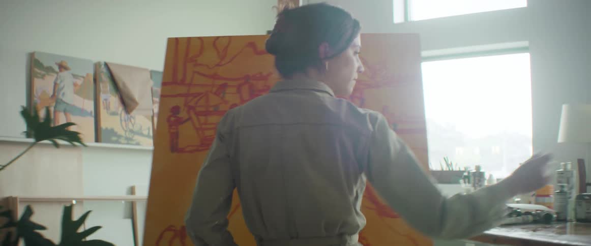 A woman painting an artistic picture in an art room