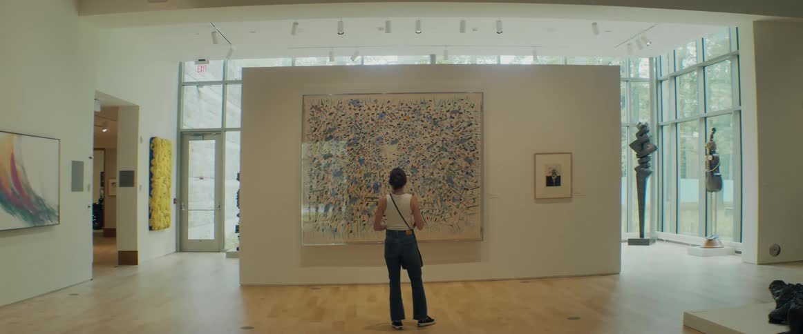 Woman looking at a large painting on an art gallery