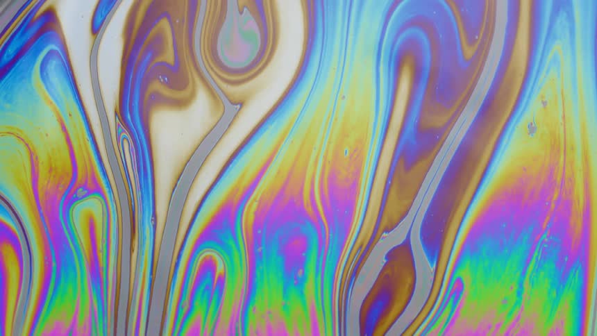 Extreme closeup of a psychedelic fluid in slow motion