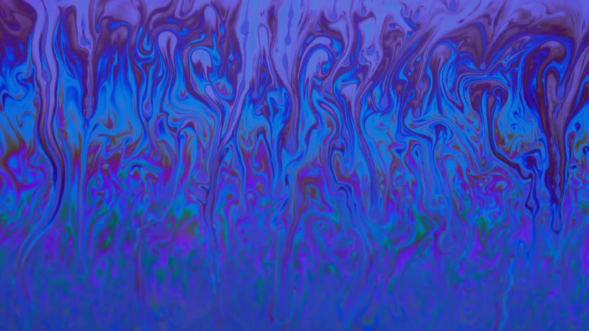 Blue liquid swirls as pink and purple move down and blend