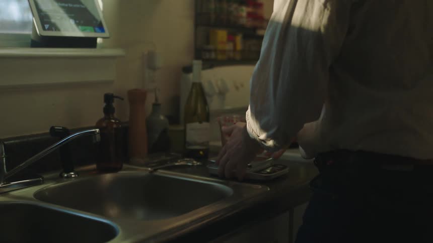 Man cleaning utensils in the kitchen at home