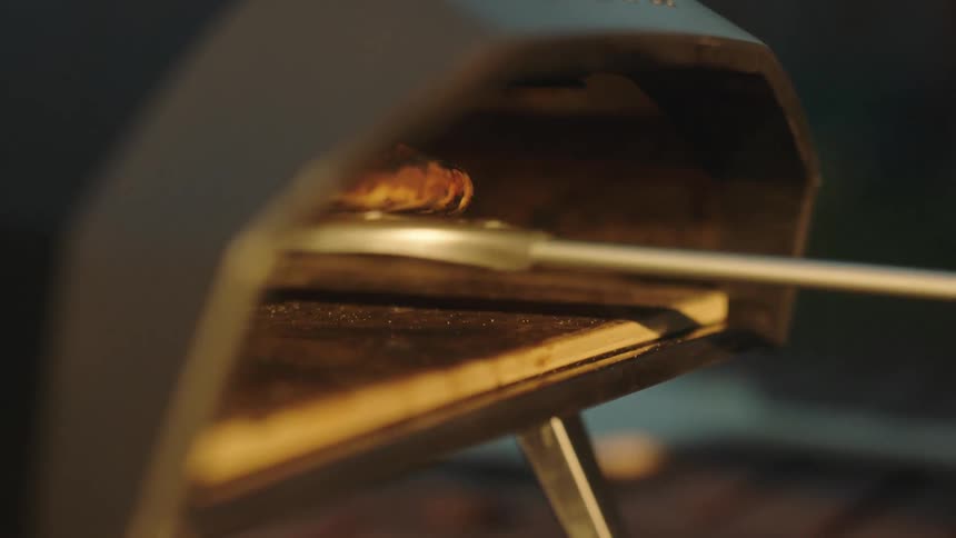 Pizza baking in an outdoor oven