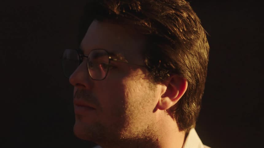 A man wearing eyeglasses under the sun