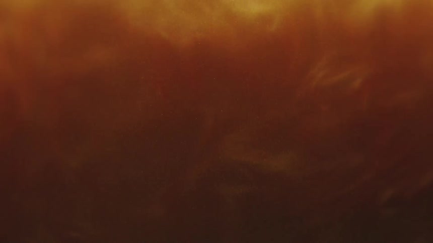 Thick amber shimmering liquid swirling
