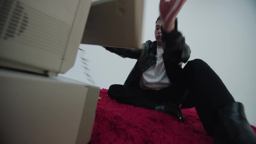 Yong man throws the keyboard of a vintage computer