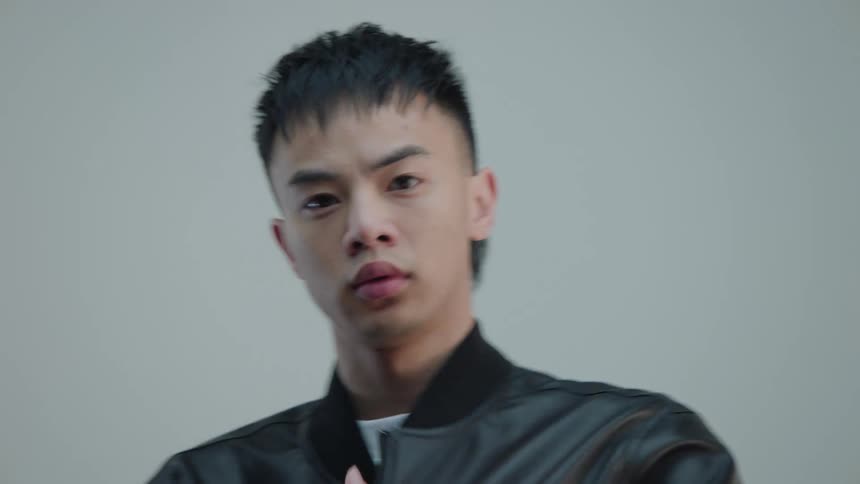 Portrait of a man modeling in a black leather bomber jacket