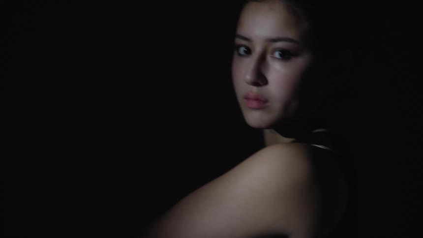 A model is posing under flashing lights