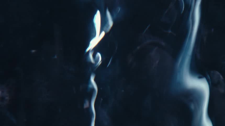 A flowing blue substance probably water undulating with particles blowing past