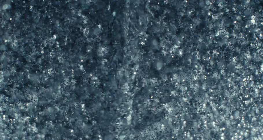 Extreme closeup of a spiral underwater causing impact and abstract bubbles