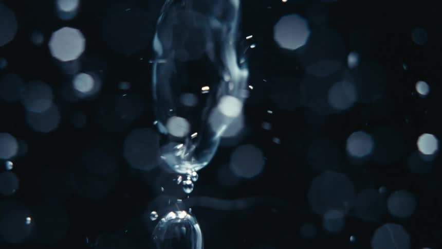 Extreme closeup of a spiral underwater with bubbles in slow motion