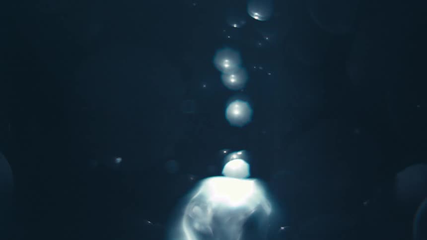 Spiral of water generating abstract bubbles in slow motion
