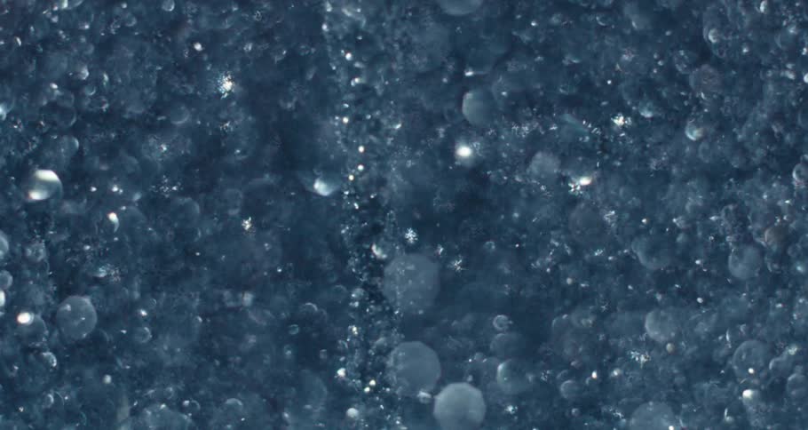 Extreme closeup of a spiral underwater with shiny bubbles in slow motion