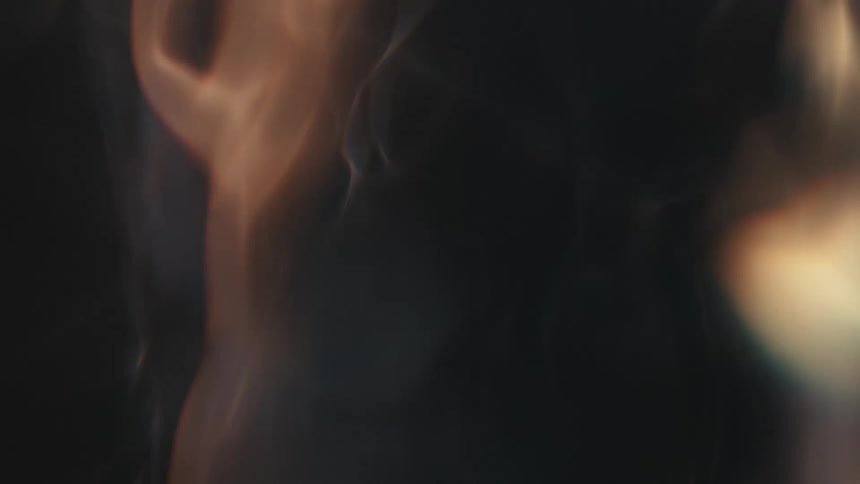 Blue and orange flame flickers on dark background
