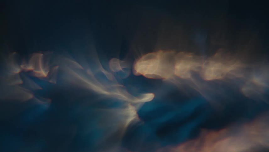 Extreme closeup of a spiral underwater with reflections