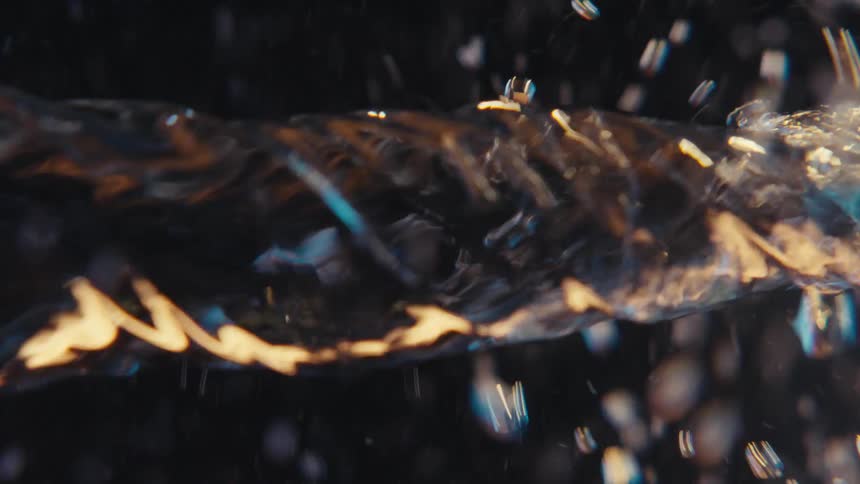 Extreme closeup of a spiral underwater causing impact and abstract bubbles