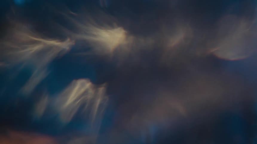Extreme closeup of a spiral underwater with reflections