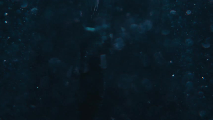 Extreme closeup underwater of a swirling motion in slow motion