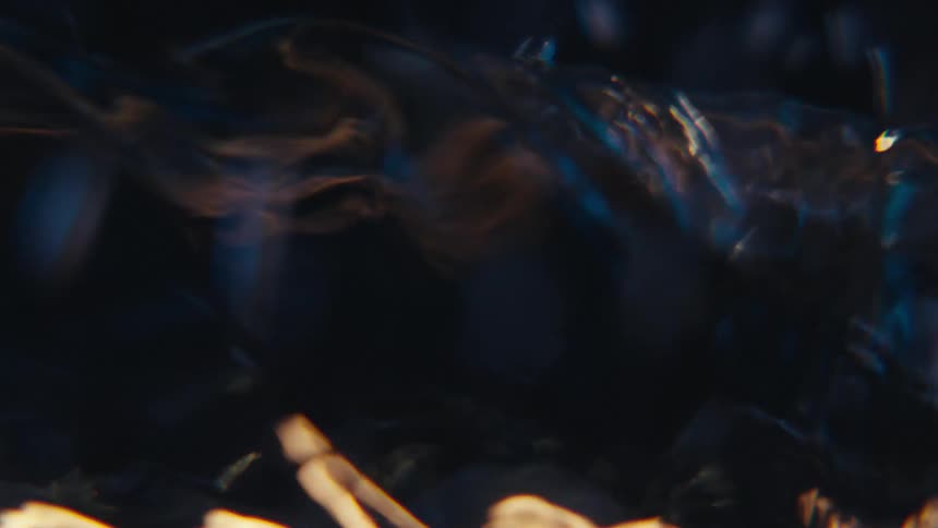 Extreme closeup of a rapidly moving and abstract spiral underwater