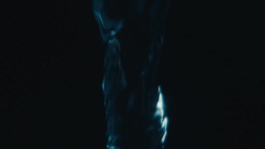 A liquid in a black environment is rising in a spiral