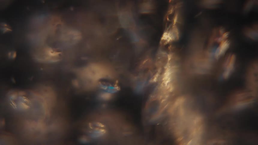 Extreme closeup underwater with a spiral forming and generating abstract bubbles