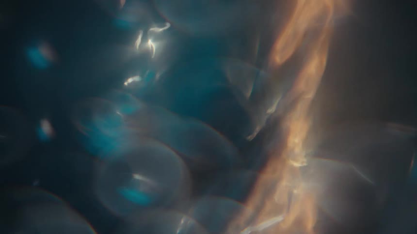 A flame of fire under the water and some bubbles rising