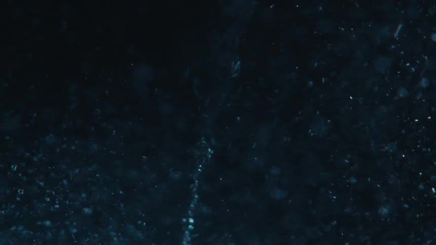 Extreme closeup of a rapidly moving and abstract spiral underwater