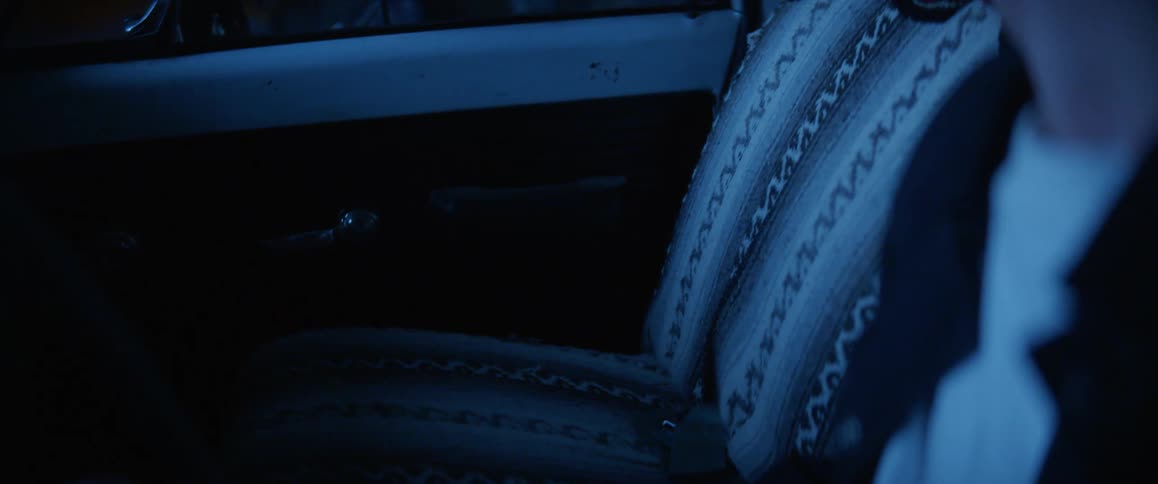 Man sits alone in truck cabin at night crying