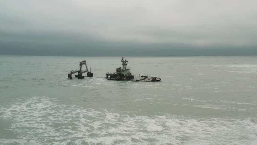 A ship is sunk in the sea and some small waves are passing close to it