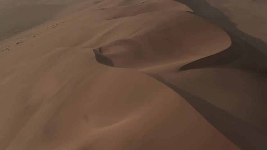 An aerial view of sand dunes in a desert