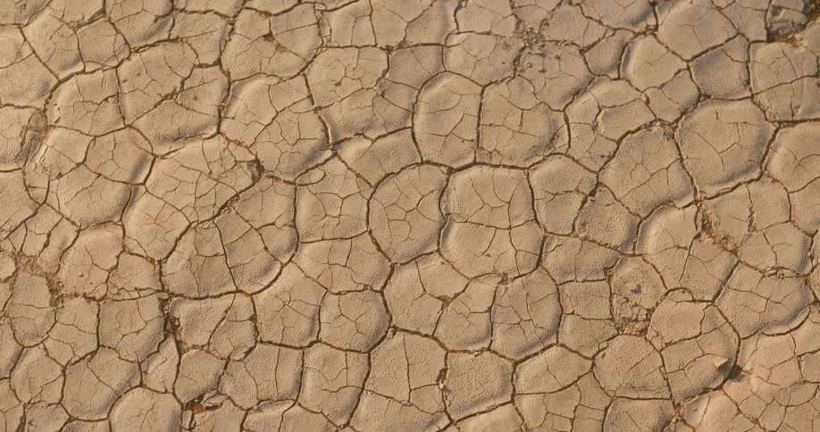Dry and cracked parched sand in the desert