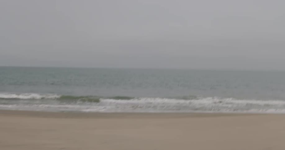 View of an empty beach on a cloudy day
