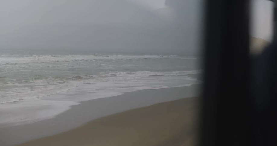 A vehicle is driving on the beach