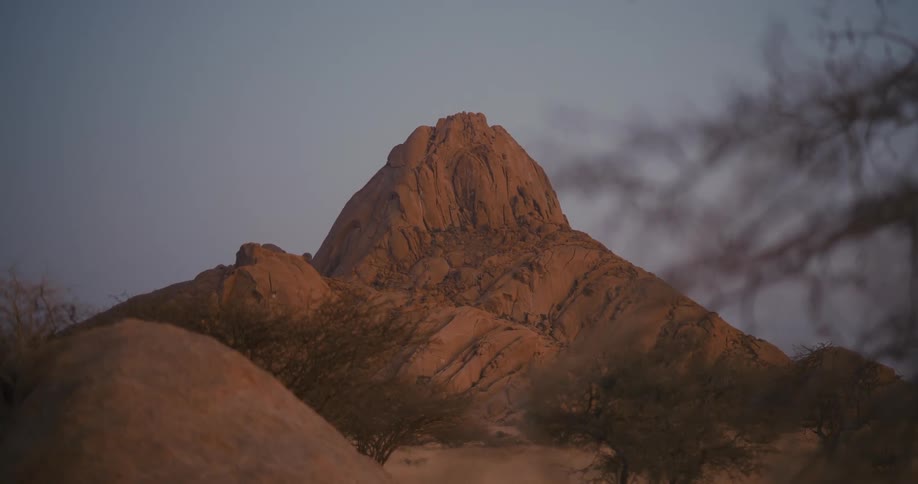 The sky is clear above the mountain