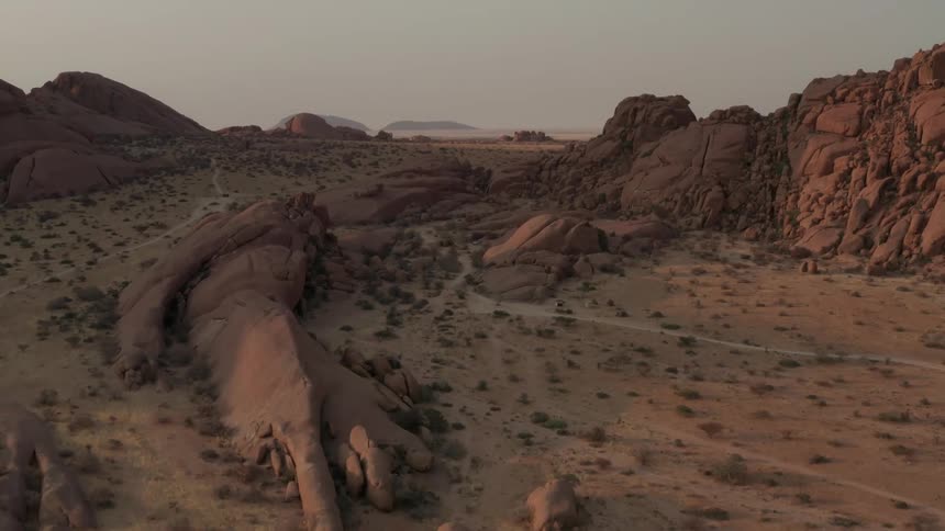Mountains and rock formations with plants and vegetation across the desert