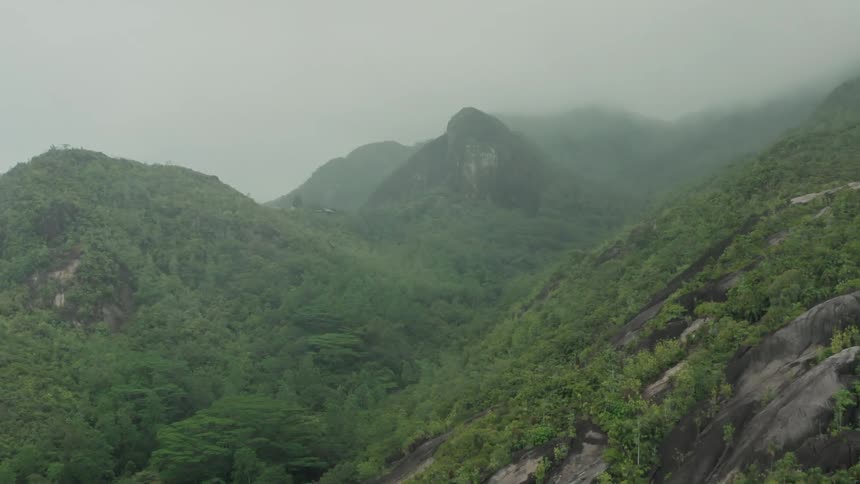Aerial view of green mountains in fog