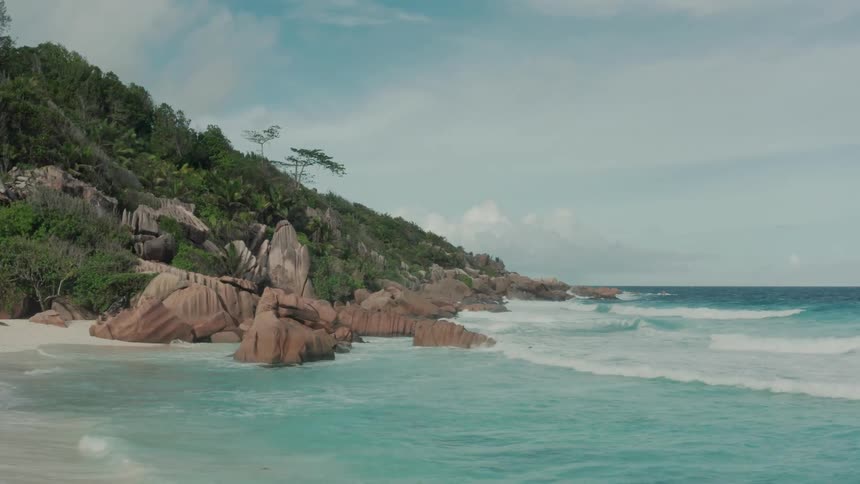 Panorama of the calm blue sea with gentle waves on a paradise island