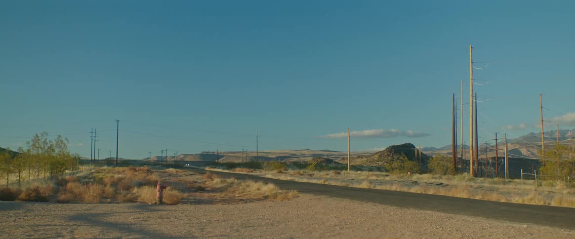 A road in the middle of the desert on a sunny day