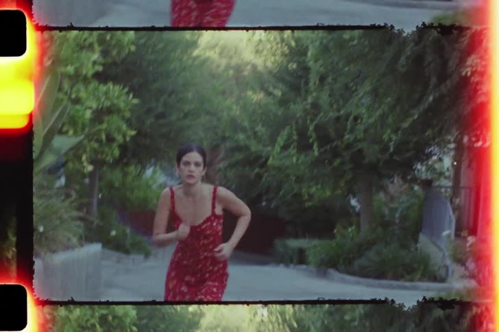 Woman running on a street in a red dress
