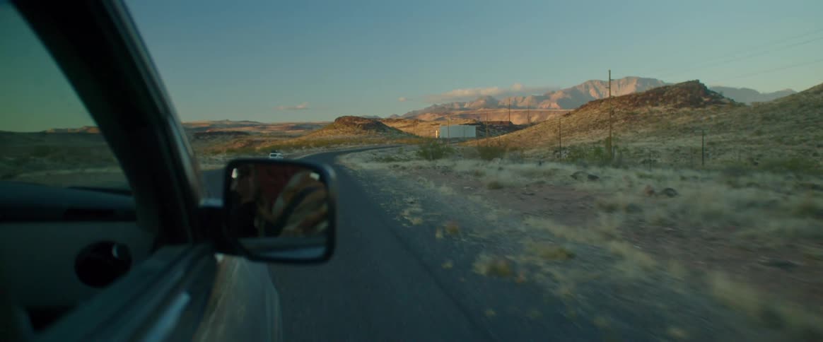 Car driving on a road through the countryside at morning