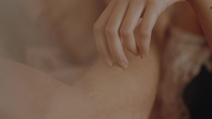 A womans hand running along a mans arm