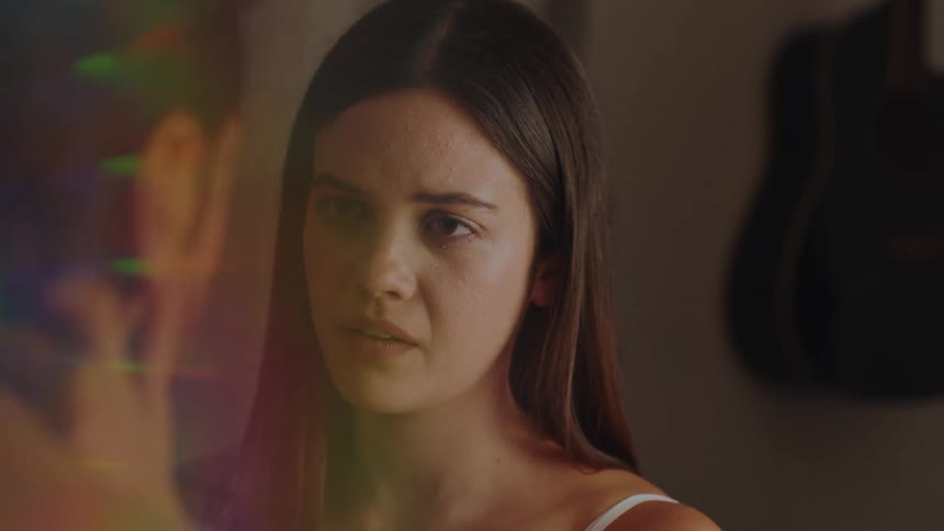 Portrait of a woman with her hands on her boyfriends face both with a sad facial expression