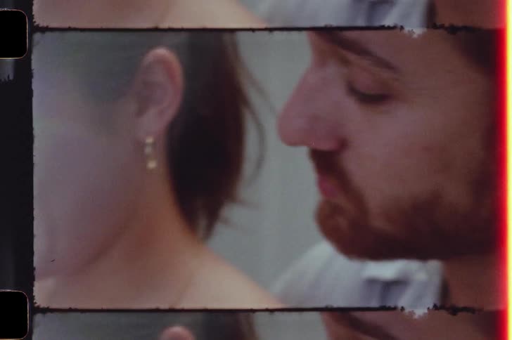 Young couple talking and joking in the kitchen caught on vintage film