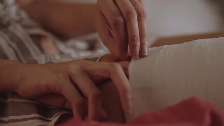 A woman sticks her fingers inside her leg cast to itch it